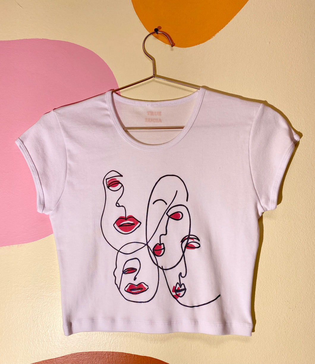 Four lined faces baby tee